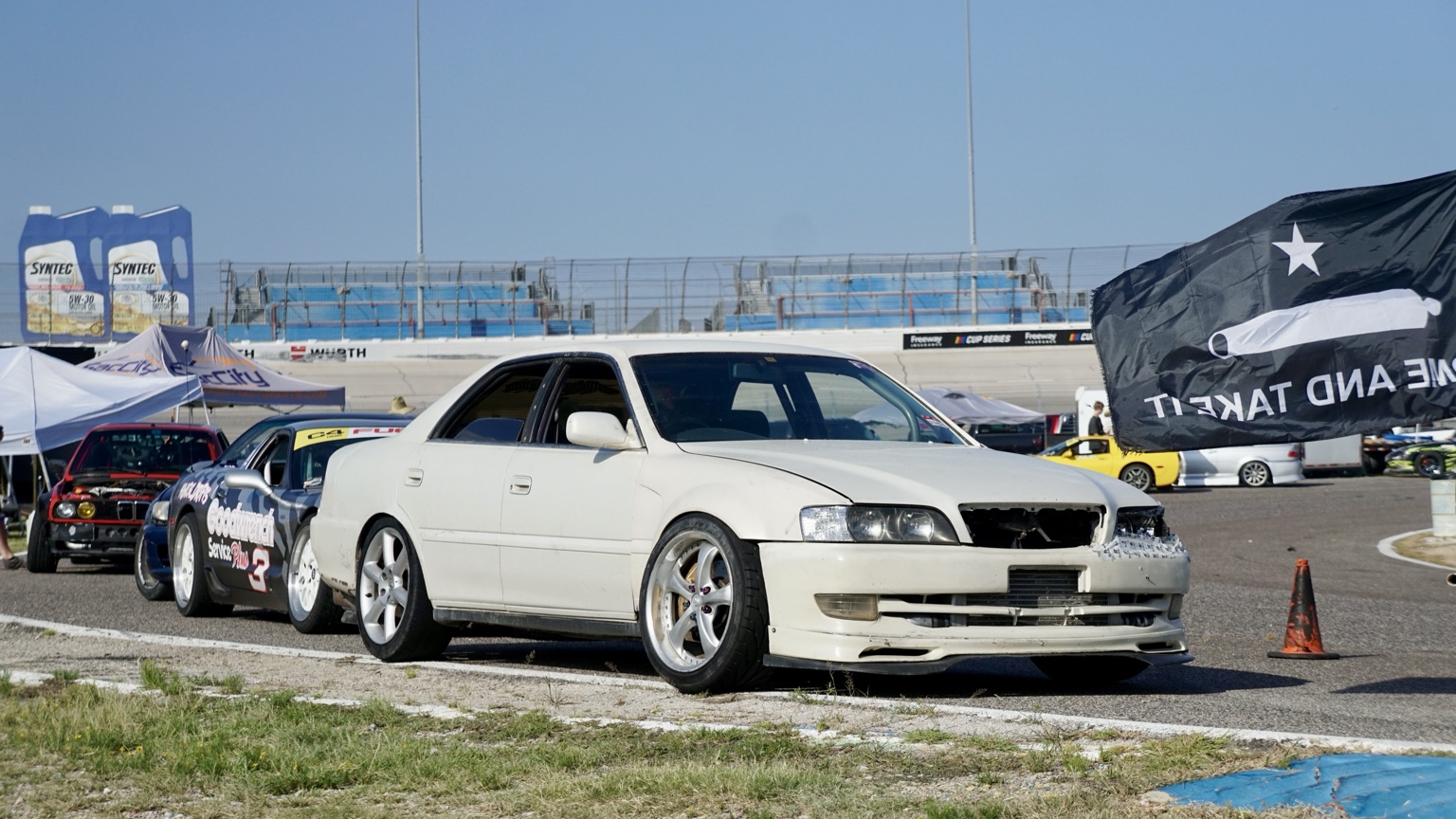 White sedan front three-quarter view