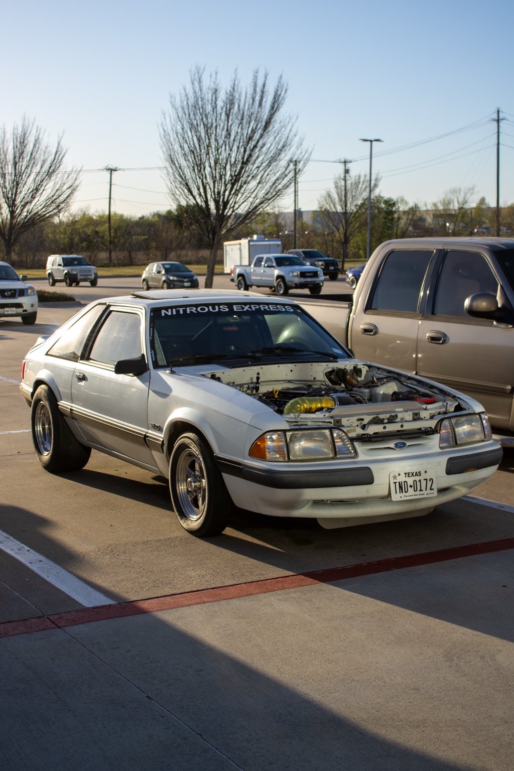 White Fox-body Ford Mustang with exposed engine bay