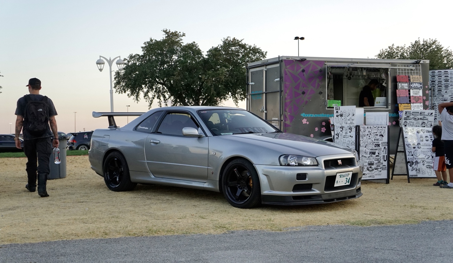 Silver Nissan Skyline GT-R at an evening meet