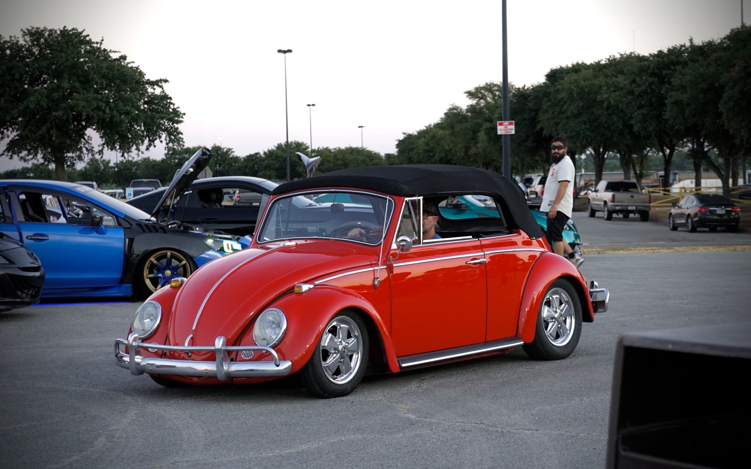 Red classic Volkswagen Beetle convertible at a car meet