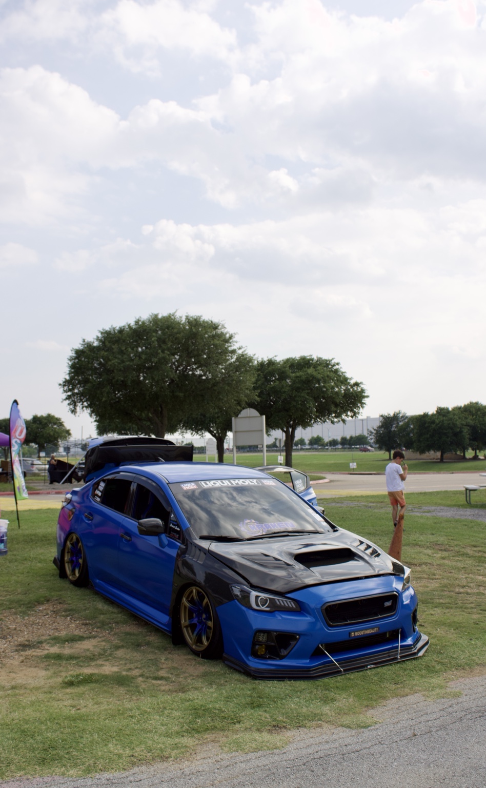Blue modified Subaru at a car meet